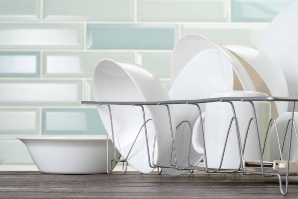 istock Dish rack with clean dry dishes on kitchen counter 2171505317