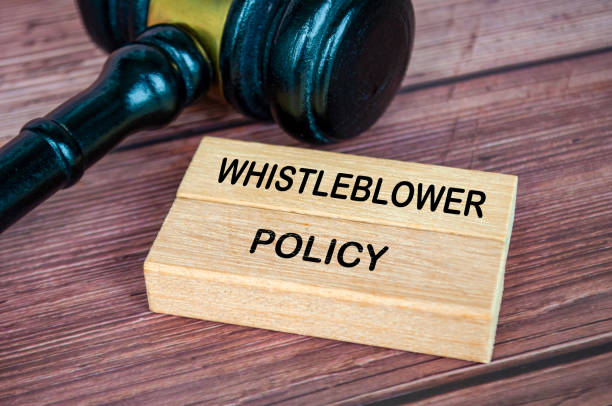 istock Whistleblower Policy text engraved on wooden blocks with gavel background 2171509442