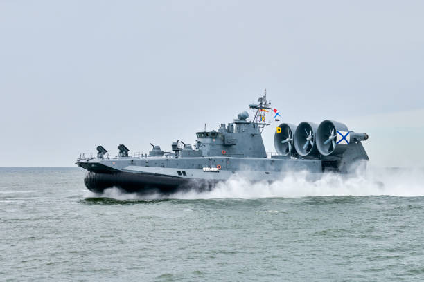 istock Hovercraft warship armed with armament sails into sea toward military target to attack and destroy 2171510558