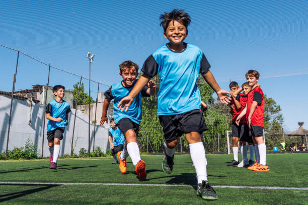 Junior football team running on the field