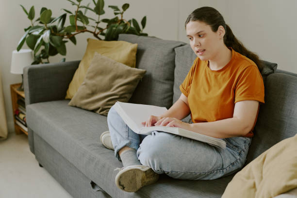 istock Young Woman Reading Braille Book 2171513158