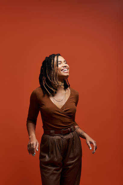istock Stylish young African American woman joyfully posing in a vibrant studio backdrop 2171513679