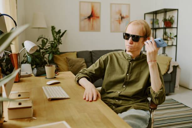 istock Man with Sunglasses Sitting at Table 2171514256