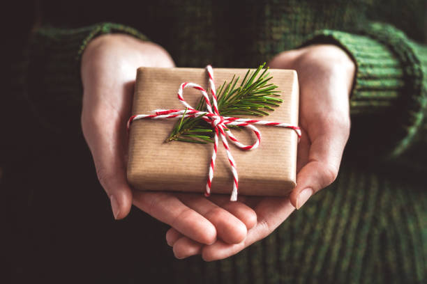 istock Hands holding little gift with red bow. Close up. 2171515835