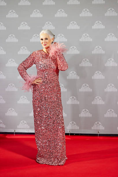 istock Mature celebrity posing against step and repeat wall 2171515967