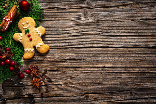 Christmas ornaments border and gingerbread cookie on wooden table. Copy space