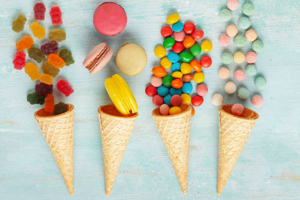 istock Different colorful candies, lollipops, marshmallows and macaroons in candy cane. Flat lay sweets on light background. Top view 2171518417