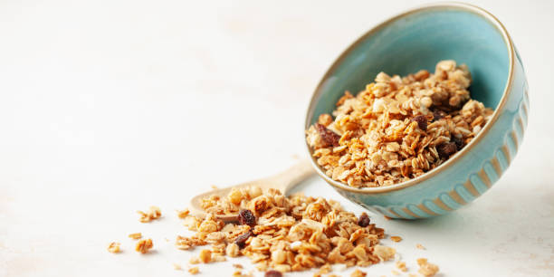 istock Tasty crispy granola in bowl on white background. Healthy breakfast. Copy space 2171518498