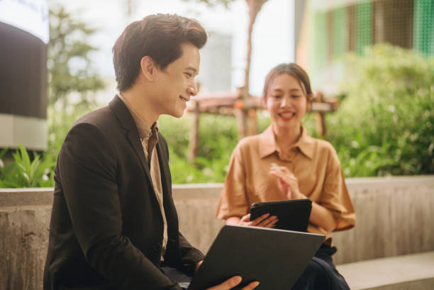istock Happy colleagues meet in public space using tablets and laptops to present new projects together. 2171519203