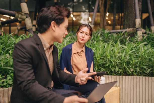 istock Happy colleagues meet in public space using tablets and laptops to present new projects together. 2171519320