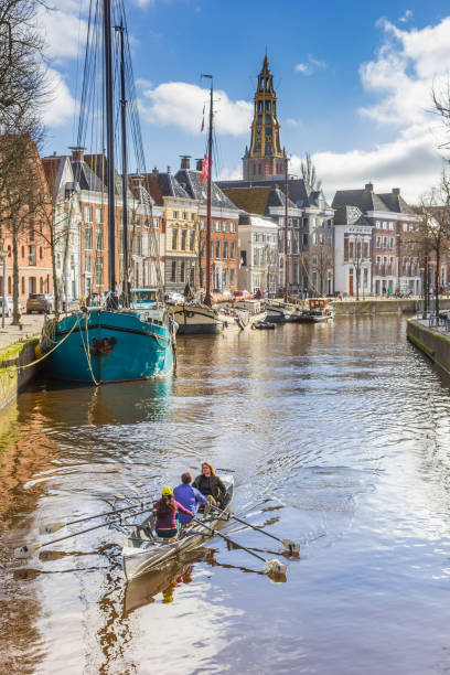 Rowboat going through the historic Hoge Der Aa canal in Groningen, Netherlands