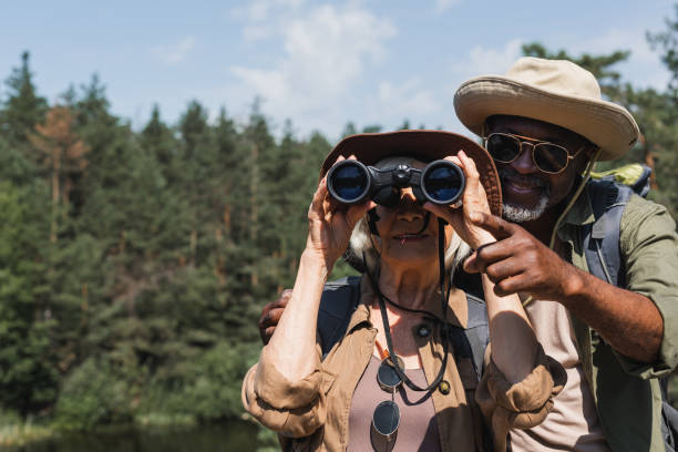 istock Senior couple enjoying a peaceful hike while exploring nature with binoculars on a sunny day 2171520196