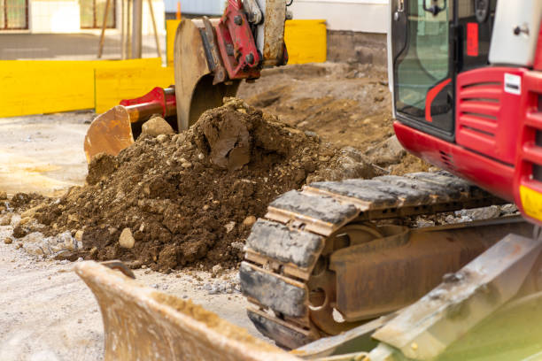 istock Excavator bucket collects soil and old asphalt at a construction site 2171520727