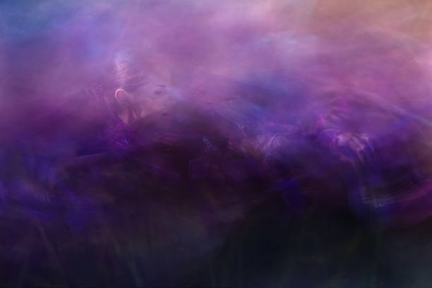 Atmospheric scene, where a woman is picking abstact light shapes of Iris flower buds.