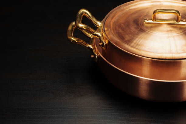 istock Shiny vintage copper cookware over dark background 2171524389