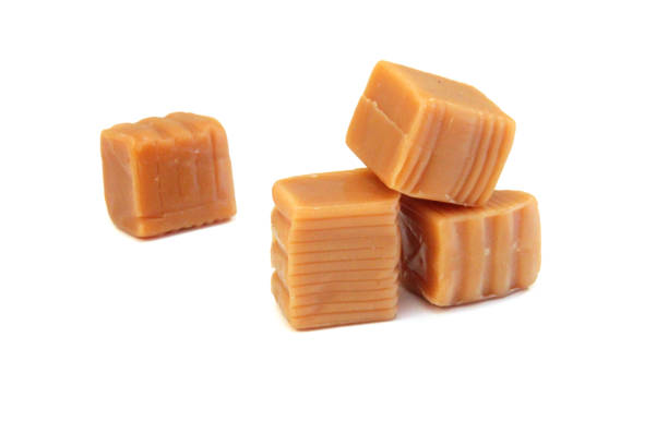 istock Caramel candies isolated on white background 2171524476