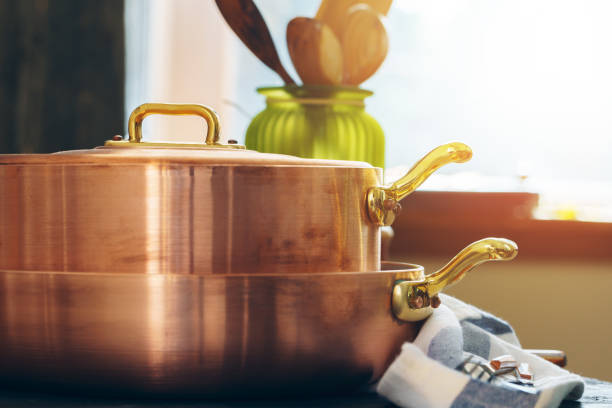 istock Copper cookware with wooden kitchen utensils close up 2171528317