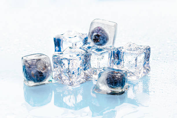 istock Frozen berries in ice cubes on pink 2171528766