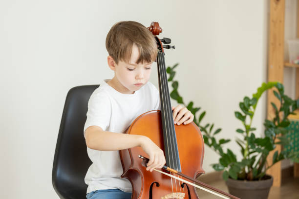 istock 6 year old boy learning to play cello 2171530176