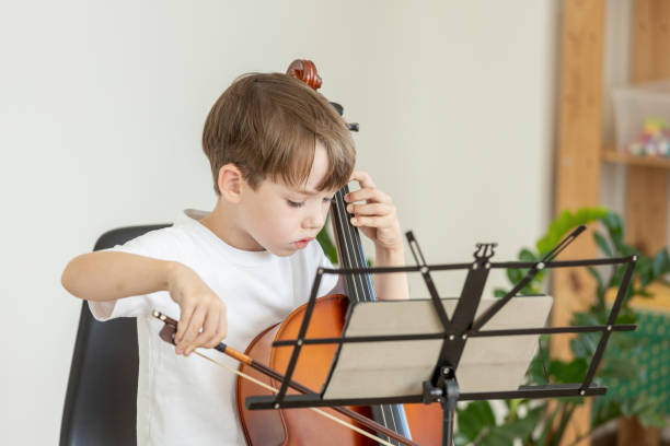 istock 6 year old boy learning to play cello 2171530180