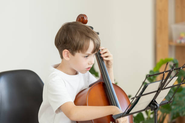 istock 6 year old boy learning to play cello 2171530187