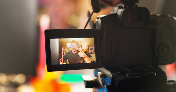 istock Happy man, influencer and camera with screen for video recording, online streaming or content creation at home. Male person, vlogger or young streamer with equipment for live broadcast or podcast 2171530857