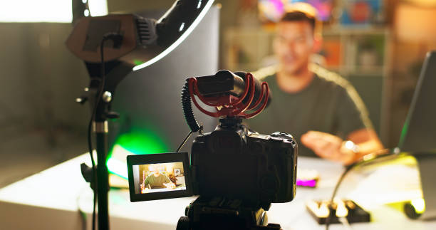 istock Man, influencer and video recording with camera for online streaming, content creation or social media at home. Male person, vlogger or young streamer with equipment or ring light for live broadcast 2171530859