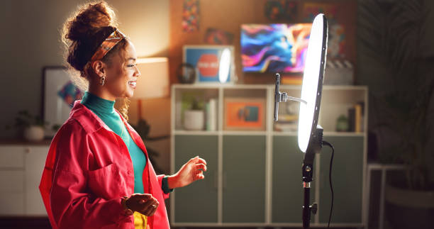 istock Happy woman, influencer and video recording with ring light for vlog, online tutorial or communication at home. Young, female person or vlogger talking with phone for advice, tips or content creation 2171531936