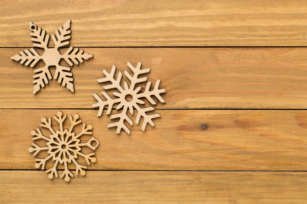 istock Beautiful snowflake on woden background, top view 2171532379