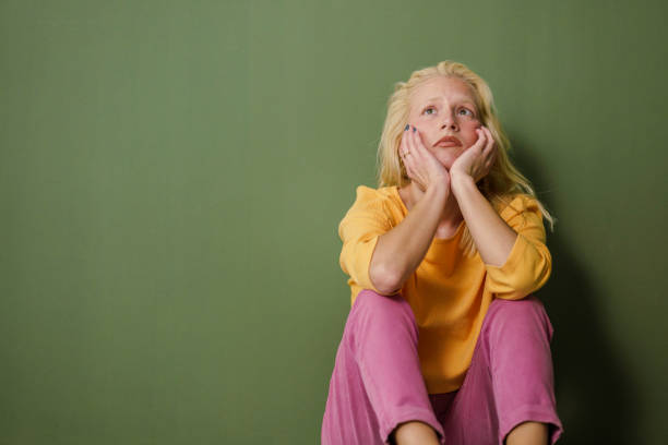 istock Stressed Young Woman on Green Background 2171532525