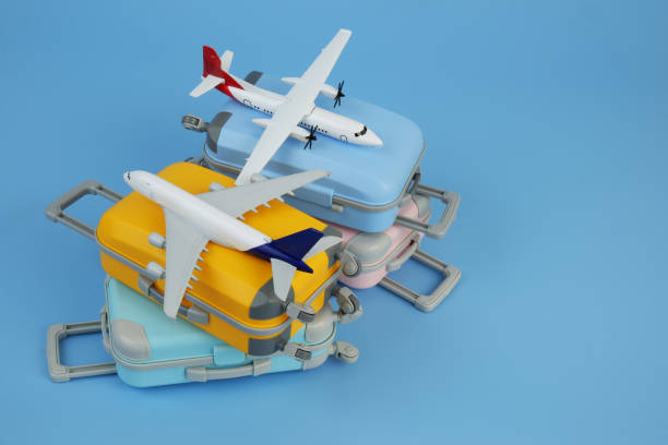 istock Airplane models on several travel suitcases on blue background. Copy space for text. 2171532764