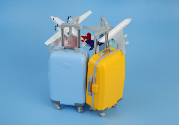 istock Airplane models on several travel suitcases on blue background. 2171532780