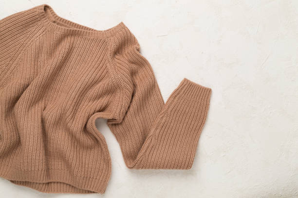 istock Brown sweater on concrete background, top view 2171534261