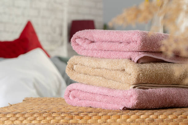 istock Stack of clean towels on wooden table in bedroom 2171535231