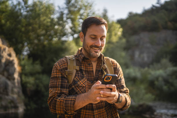 istock Adult man explore nature while check mobile phone in a serene setting 2171576196