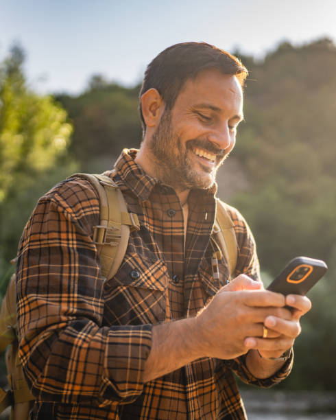 istock Adult man explore nature while check mobile phone in a serene setting 2171576410