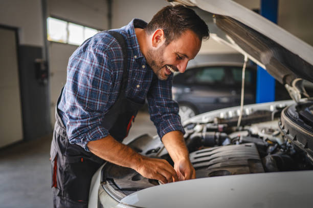 istock Car mechanic work under car hood in garage, maintaining vehicle engine 2171576478
