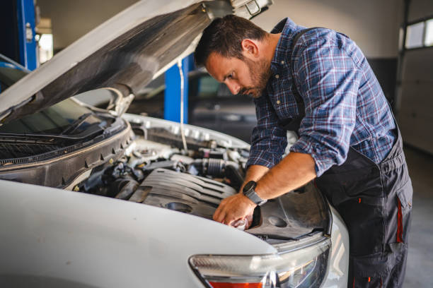 istock Car mechanic work under car hood in garage, maintaining vehicle engine 2171576511