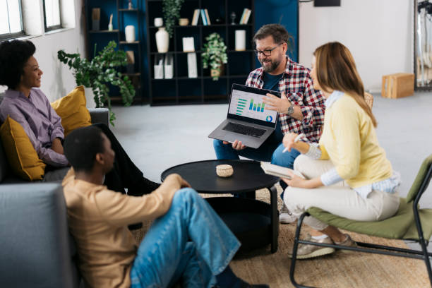 istock Entrepreneur explaining statistical data on laptop to colleagues in startup meeting 2171577993