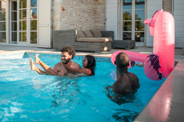 istock Diverse Couple Swimming and Hugging at Pool Party 2171605540