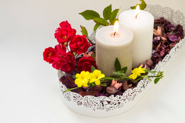 Close-up taken of two candles in metal,decorative tray with dry flowers.Conceptual image of special days.
