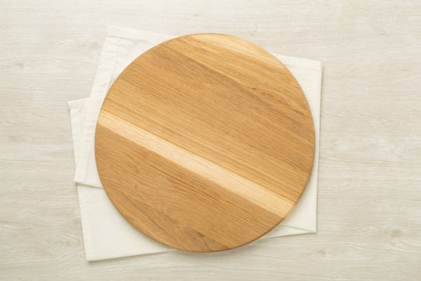 istock Cutting board with napkin on wooden background, top view 2171609860