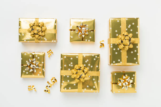istock Golden gift boxes and confetti on color background, top view 2171610632