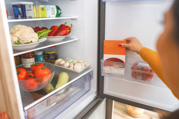 istock Organizing fresh vegetables and snacks inside a modern refrigerator on a sunny afternoon in a cozy kitchen space 2171610723