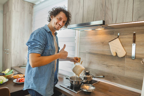 istock Enthusiastic chef enjoying a moment in a modern kitchen while preparing a meal with fresh ingredients and a cheerful expression 2171610732