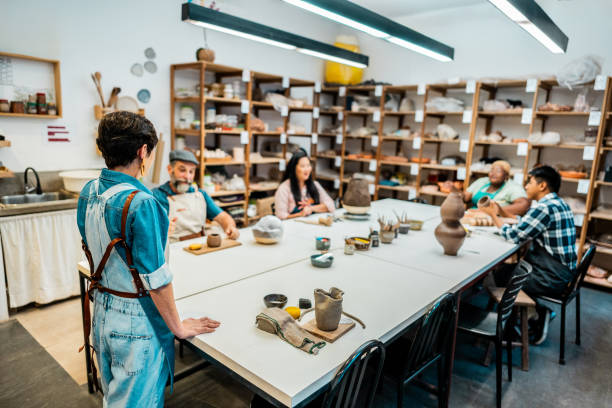 istock Pottery teacher talking to a students at a ceramics workshop 2171611129