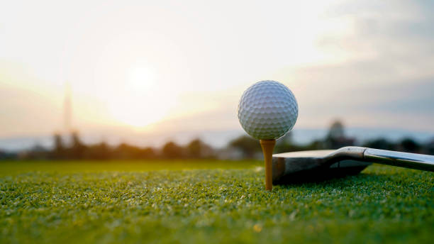 istock Golf ball on tee with sunrise background. 2171612290