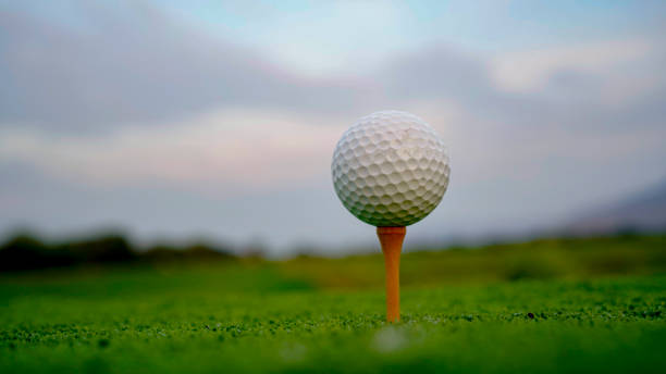 istock Golf ball on tee with sunrise background. 2171612291