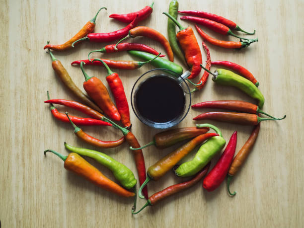 istock Horizontal Flat Lay with Coffee and Chili Peppers on a Wooden Table 2171612413