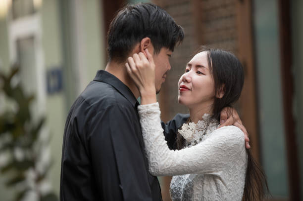Asian young couple looking each other, male and female spending time together